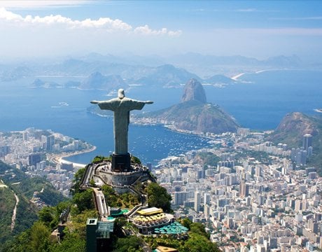 Christ the Redeemer statue overlooking Rio de Janeiro with Sugarloaf Mountain in the background | MSC Cruises Christ the Redeemer statue overlooking Rio de Janeiro with Sugarloaf Mountain in the background | MSC Cruises