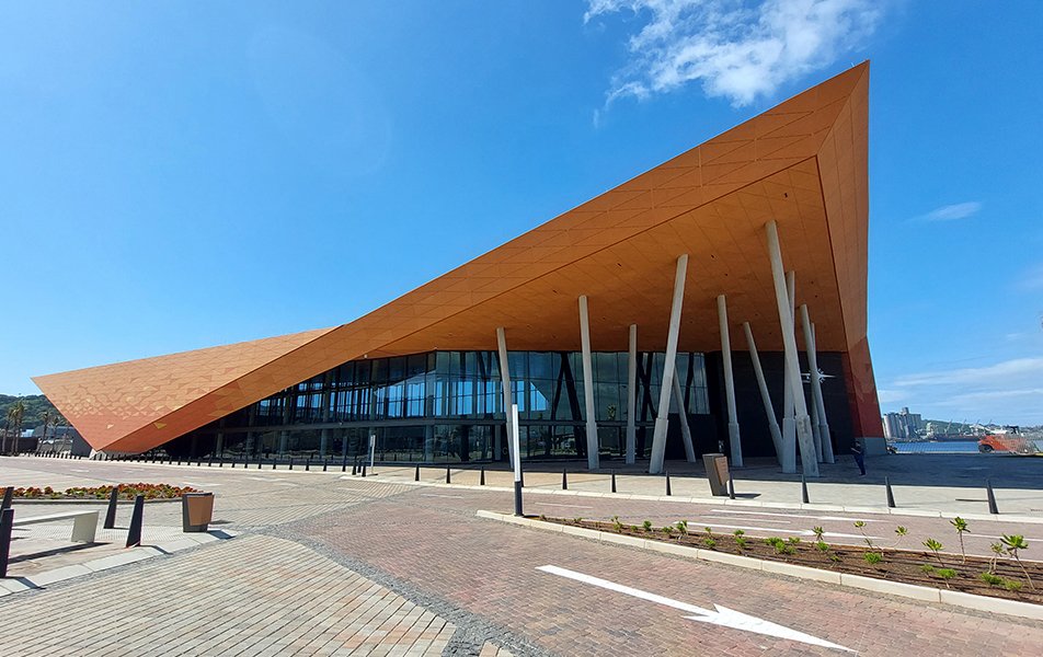 A modern architectural building with a striking angular roof and large glass windows | MSC Cruises A modern architectural building with a striking angular roof and large glass windows | MSC Cruises