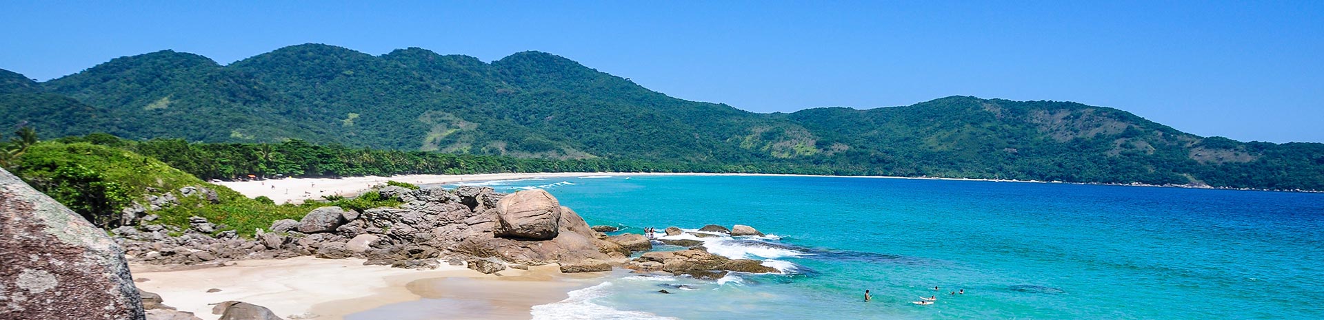 A pristine beach with turquoise waters and lush green mountains | MSC Cruises A pristine beach with turquoise waters and lush green mountains | MSC Cruises