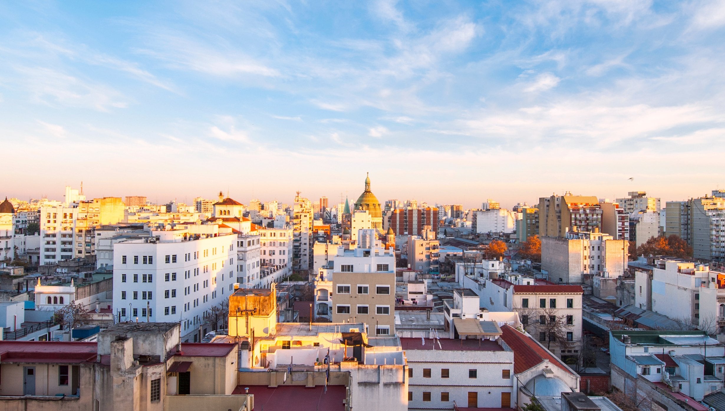 A panoramic view of Buenos Aires with historic architecture under a vibrant sky | MSC Cruises