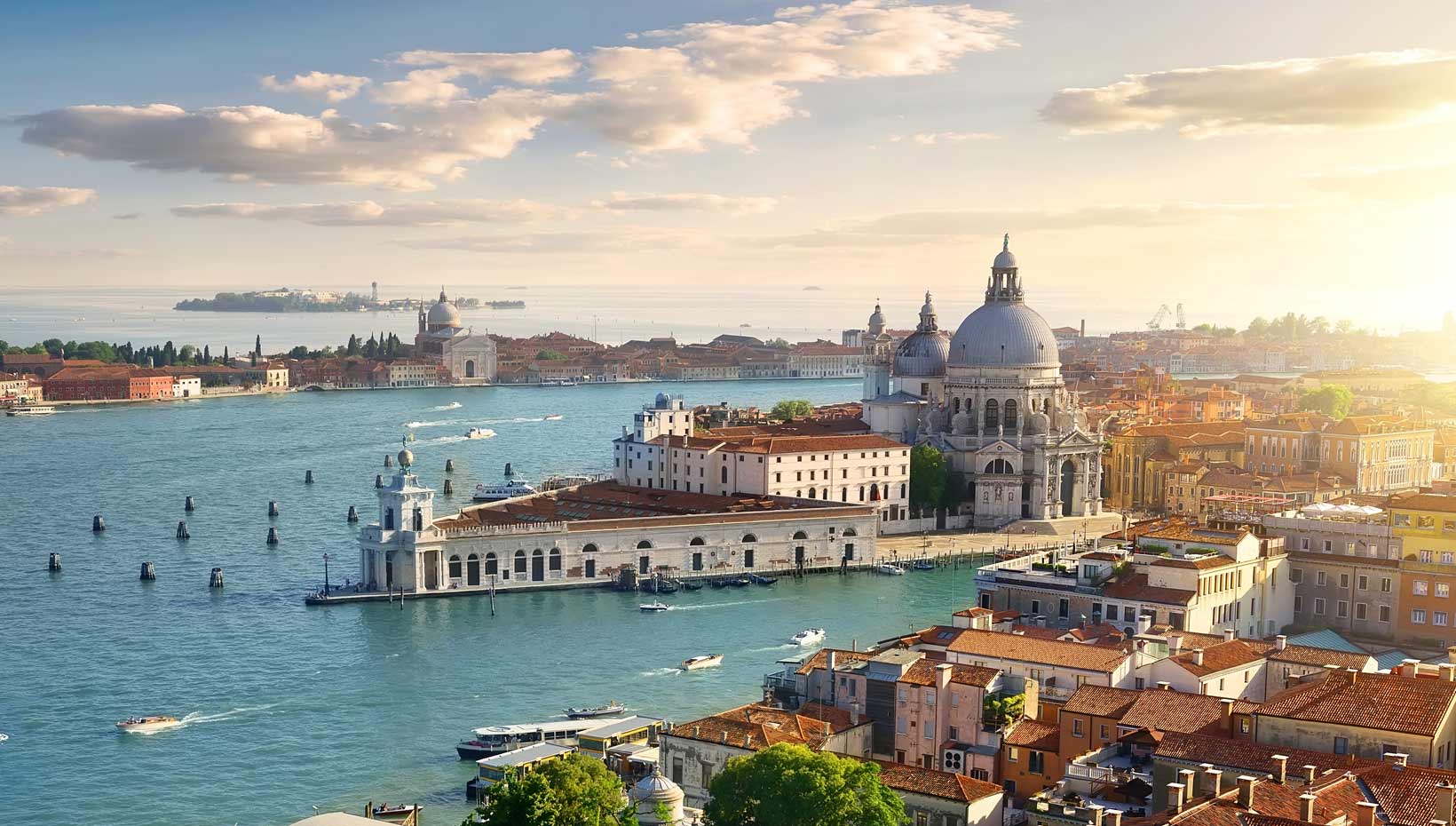 Venice's Grand Canal with historic architecture and a serene sunset | MSC Cruises