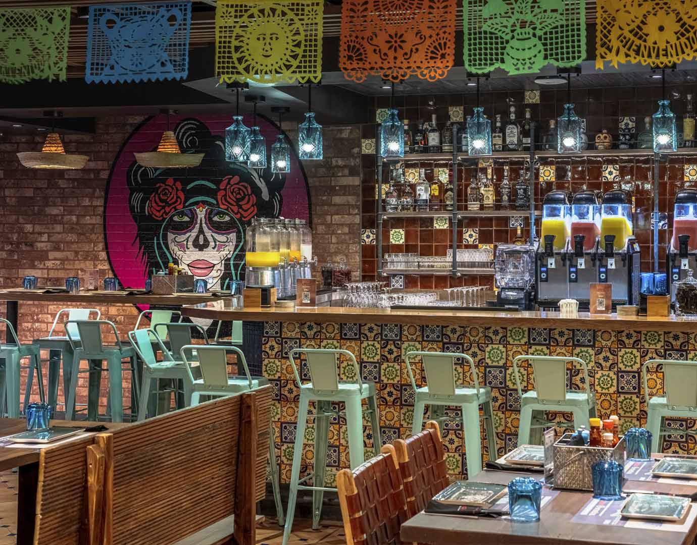 A vibrant bar with colorful decor and drinks onboard the cruise ship | MSC Cruises A vibrant bar with colorful decor and drinks onboard the cruise ship | MSC Cruises